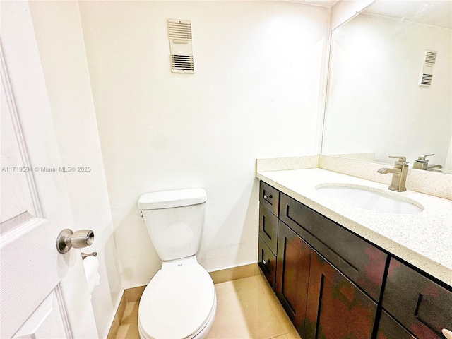 bathroom featuring tile patterned floors, vanity, and toilet