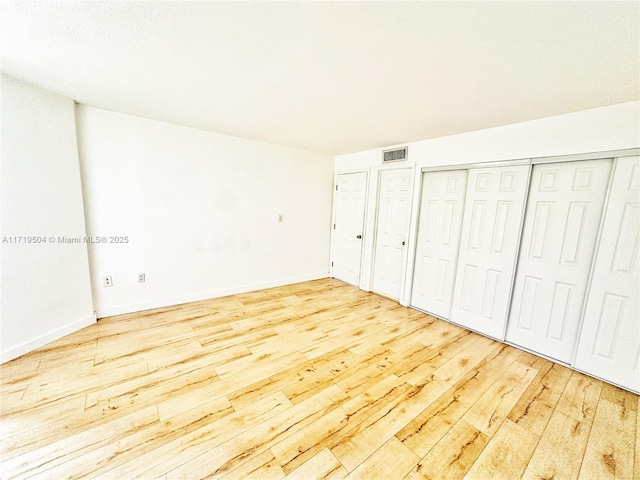 unfurnished bedroom with light hardwood / wood-style flooring