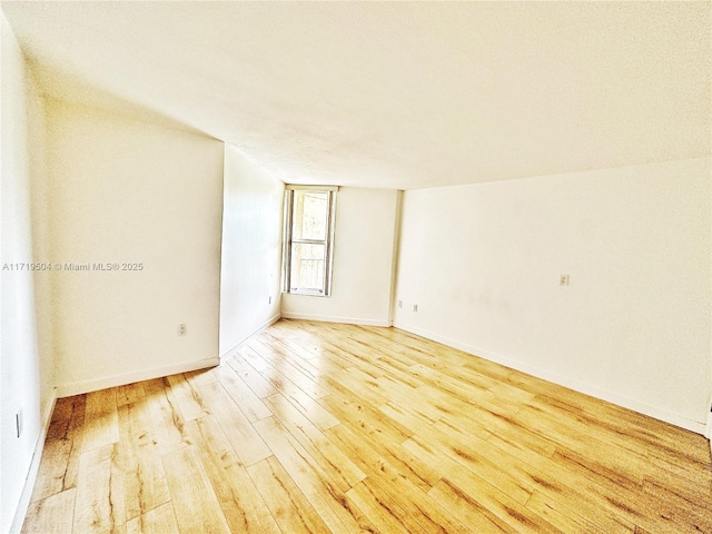 unfurnished room with hardwood / wood-style floors