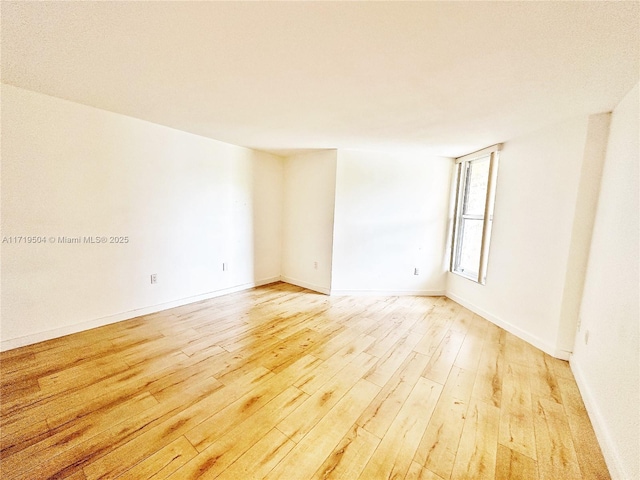 empty room with light hardwood / wood-style floors