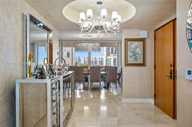 interior space featuring an inviting chandelier and a tray ceiling