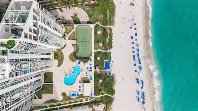 bird's eye view featuring a water view and a beach view