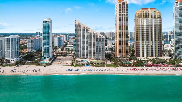 property's view of city featuring a water view and a view of the beach