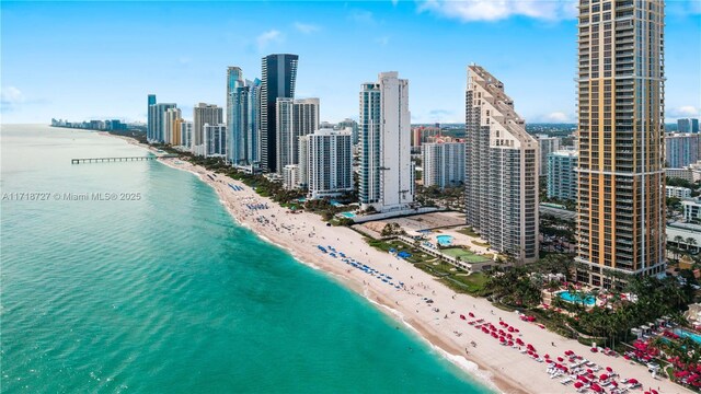 drone / aerial view with a water view and a beach view