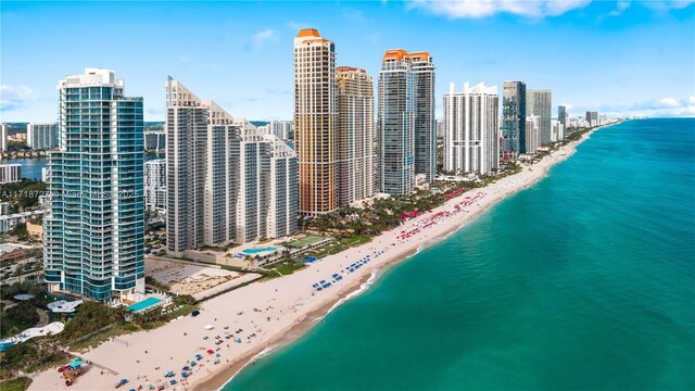 aerial view with a water view and a beach view