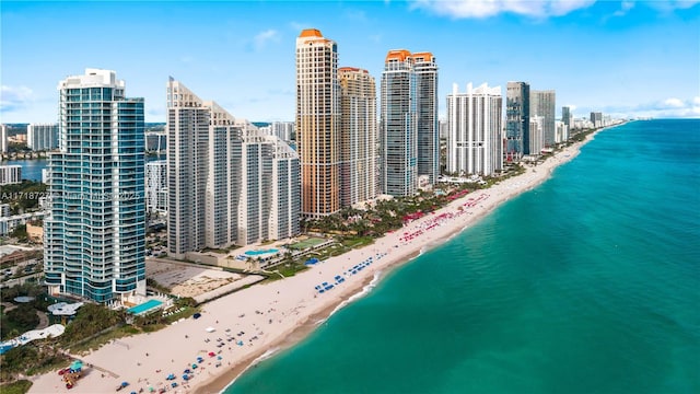 birds eye view of property with a beach view and a water view