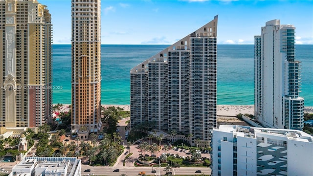 exterior space with a water view and a view of the beach