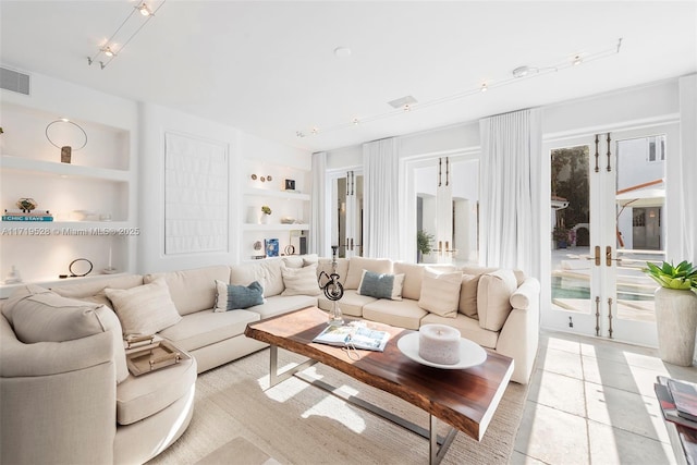 tiled living room with french doors and built in features