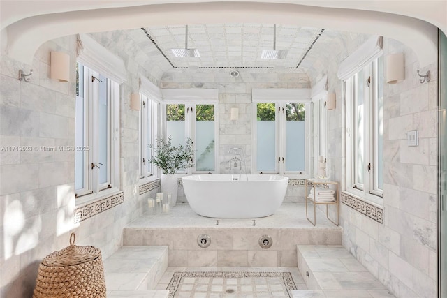 bathroom featuring sink, tile walls, and a tub