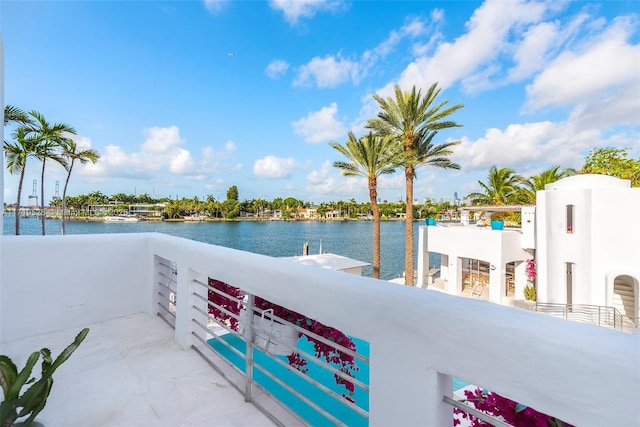 view of patio / terrace with a water view and a balcony