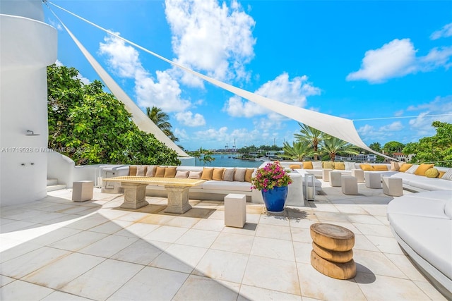 view of patio / terrace with an outdoor hangout area and a water view