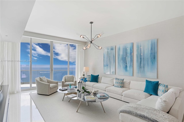 living room featuring a water view, plenty of natural light, expansive windows, and a notable chandelier