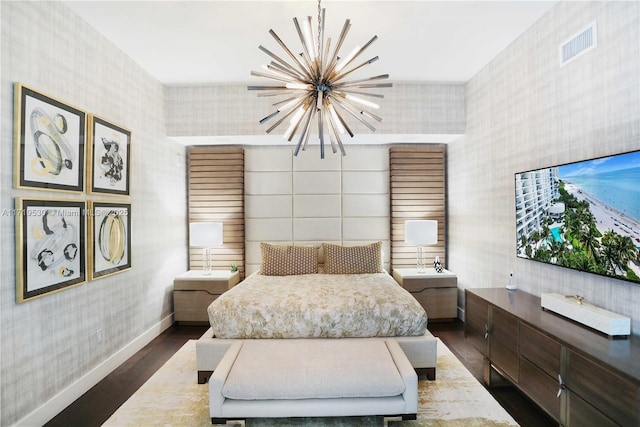 bedroom featuring dark wood-type flooring and a chandelier