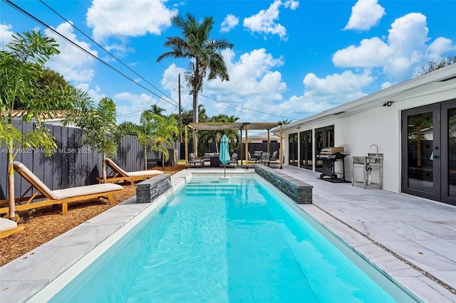 view of swimming pool featuring a patio area and a grill