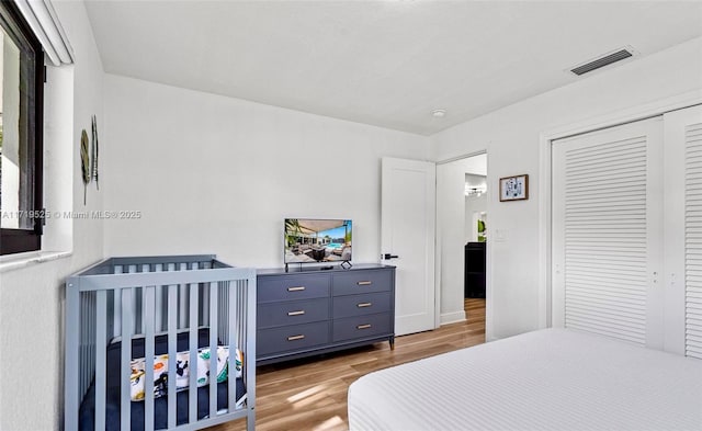 bedroom with hardwood / wood-style flooring and a closet