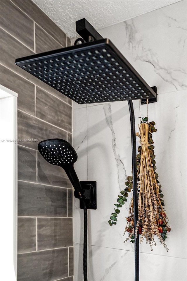 details featuring a textured ceiling and a tile shower