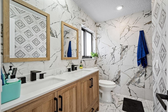 bathroom featuring a textured ceiling, toilet, and vanity