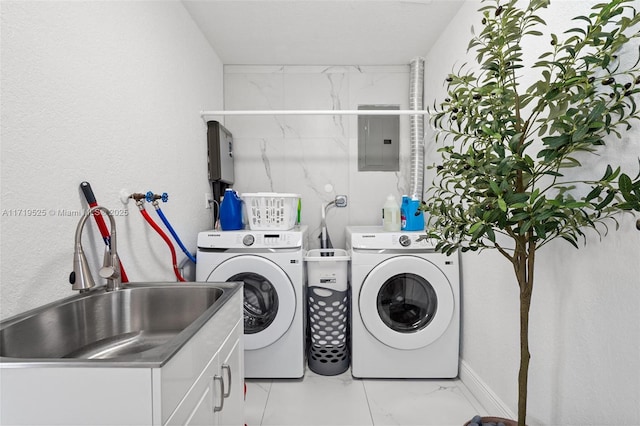 laundry area with cabinets, electric panel, separate washer and dryer, and sink