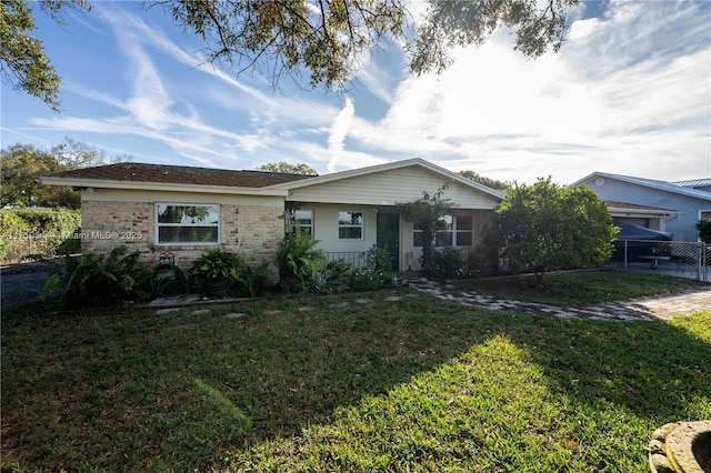 single story home featuring a front yard