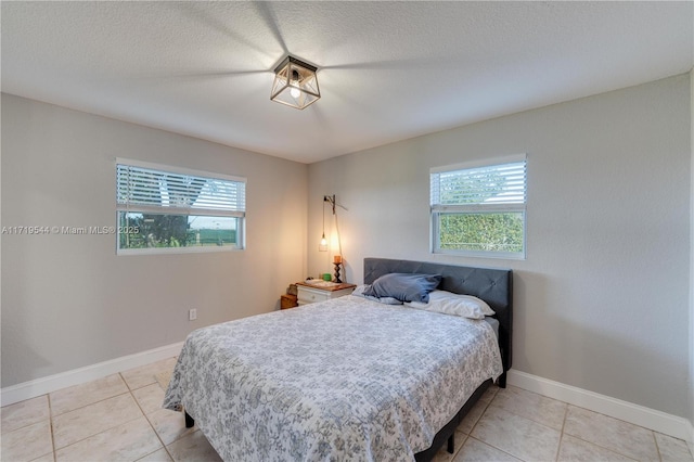 bedroom featuring light tile patterned floors