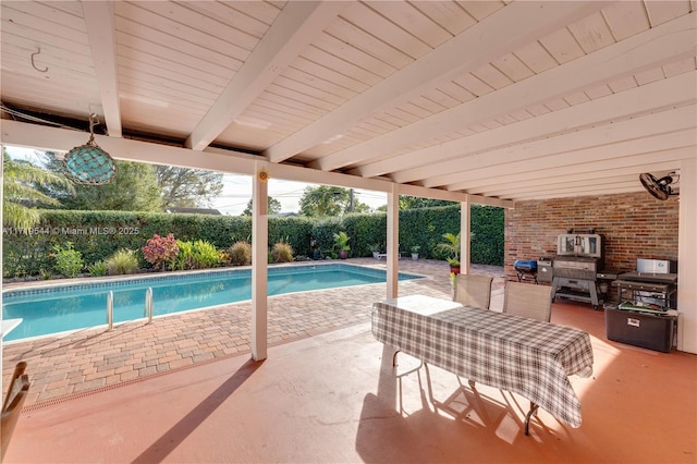 view of pool featuring exterior kitchen and a patio