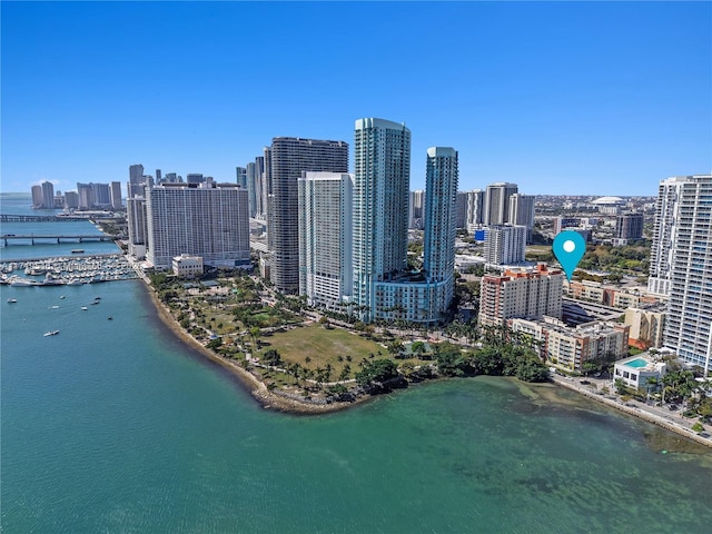 birds eye view of property featuring a water view and a city view