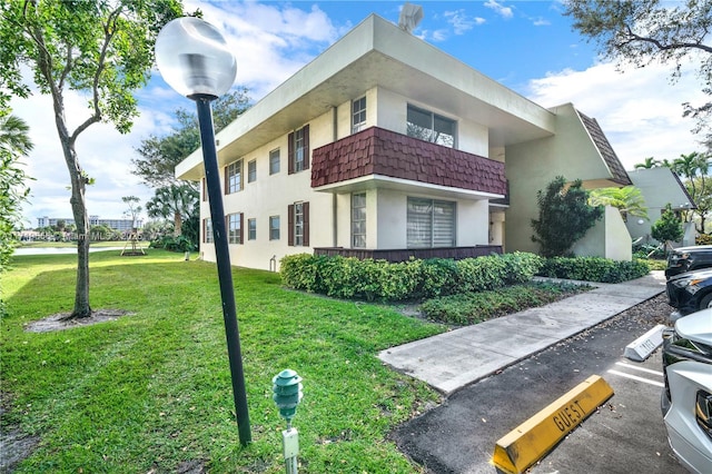 view of property exterior featuring a lawn