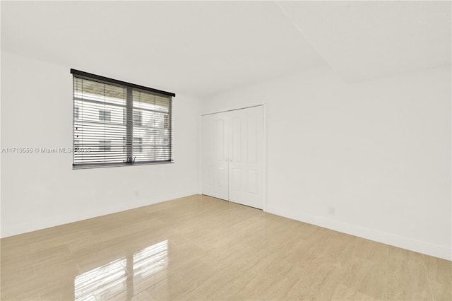 unfurnished room with light wood-type flooring