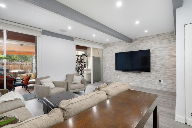 living room with light wood-type flooring and beamed ceiling