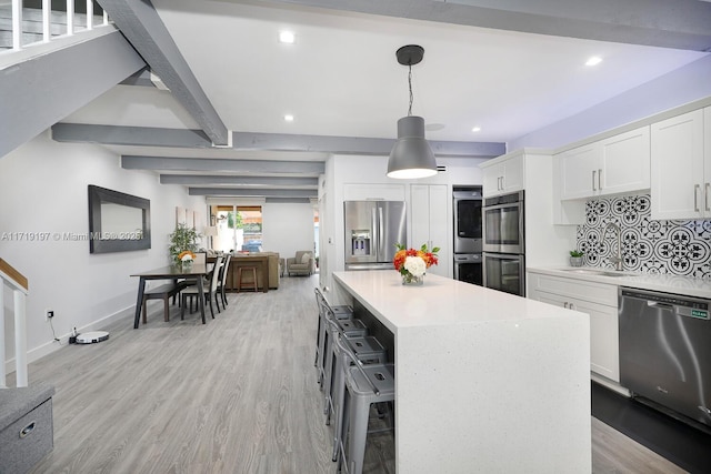 living room with light hardwood / wood-style flooring and beamed ceiling