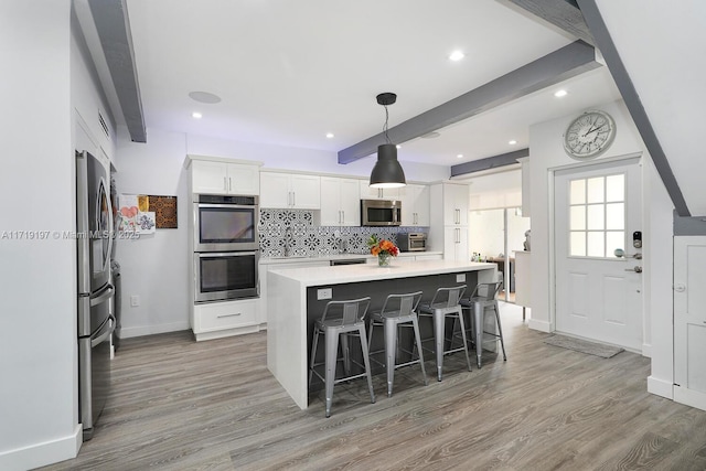 dining room with beam ceiling and light hardwood / wood-style flooring