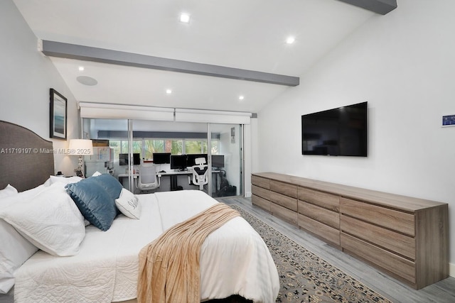 bedroom with lofted ceiling with beams and light hardwood / wood-style flooring