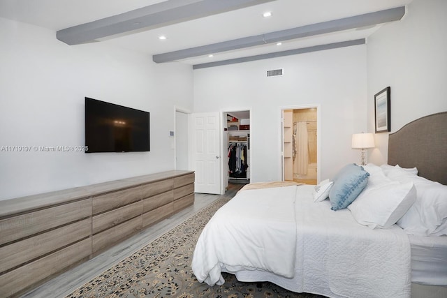 bedroom featuring hardwood / wood-style flooring and lofted ceiling with beams