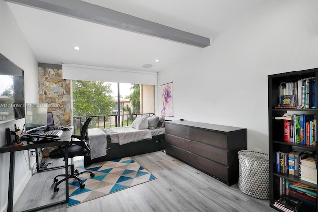 bedroom with vaulted ceiling with beams and light hardwood / wood-style flooring