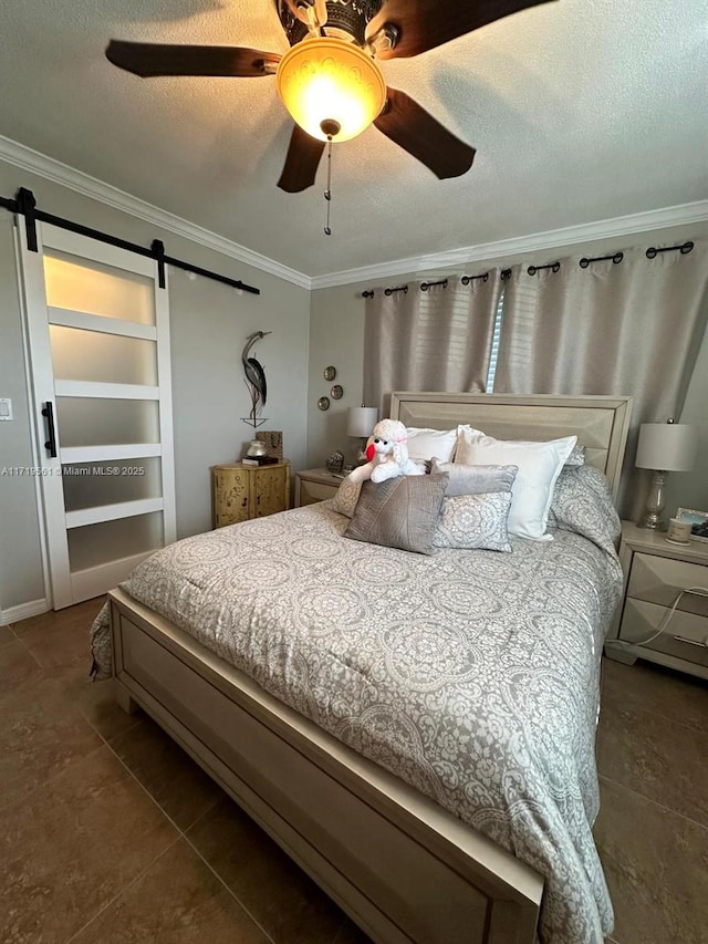 bedroom with a barn door, ceiling fan, and crown molding