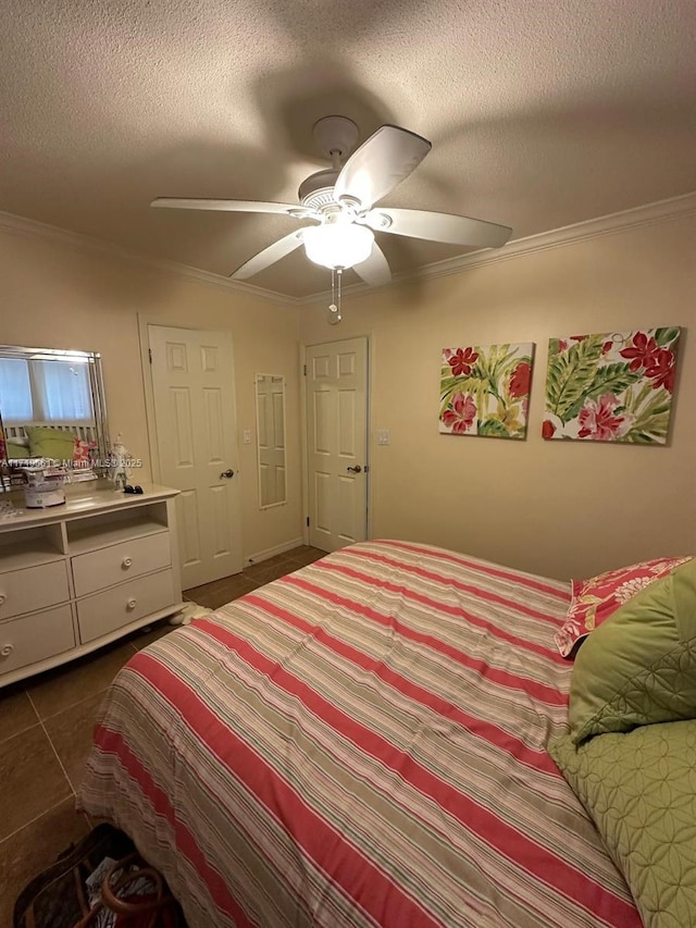 bedroom featuring a textured ceiling, dark tile patterned floors, ceiling fan, and crown molding