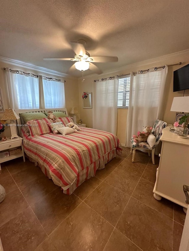 bedroom featuring ceiling fan, crown molding, and a textured ceiling