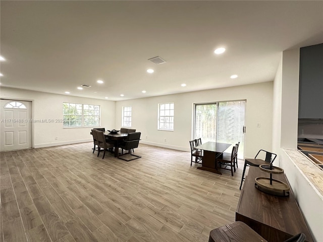 dining space featuring plenty of natural light and light wood-type flooring