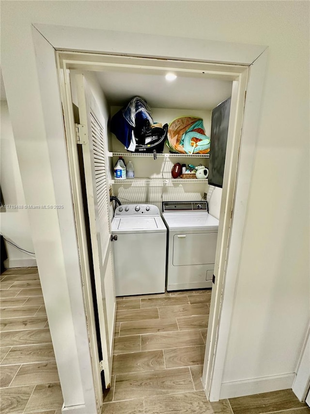 clothes washing area featuring independent washer and dryer