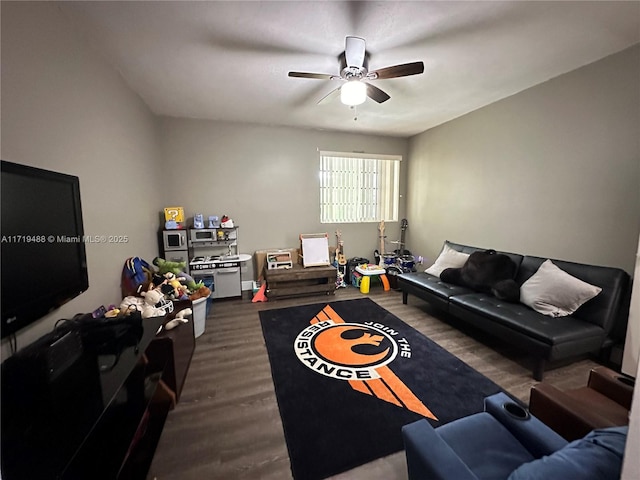 living room with dark hardwood / wood-style flooring and ceiling fan