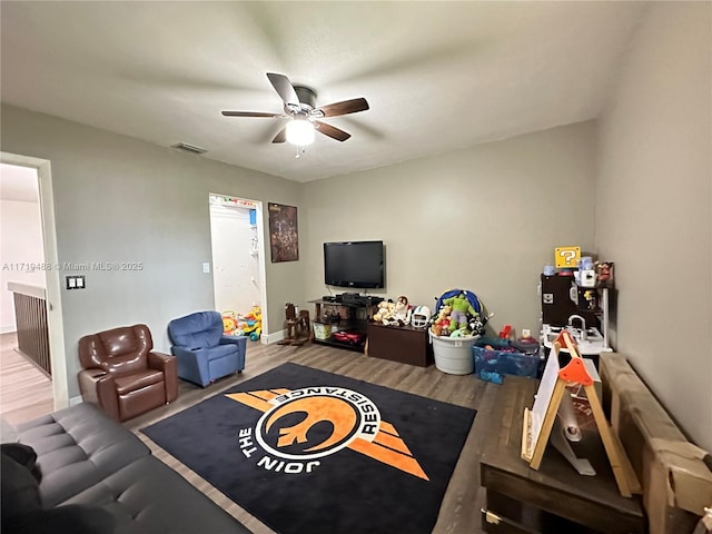 living room with ceiling fan and hardwood / wood-style floors