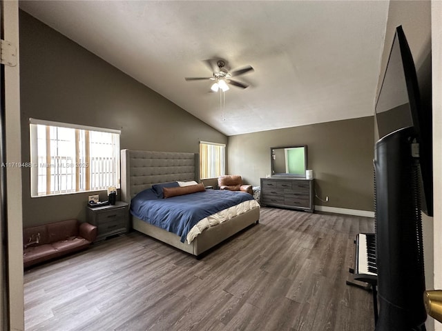 bedroom with hardwood / wood-style flooring, ceiling fan, and high vaulted ceiling