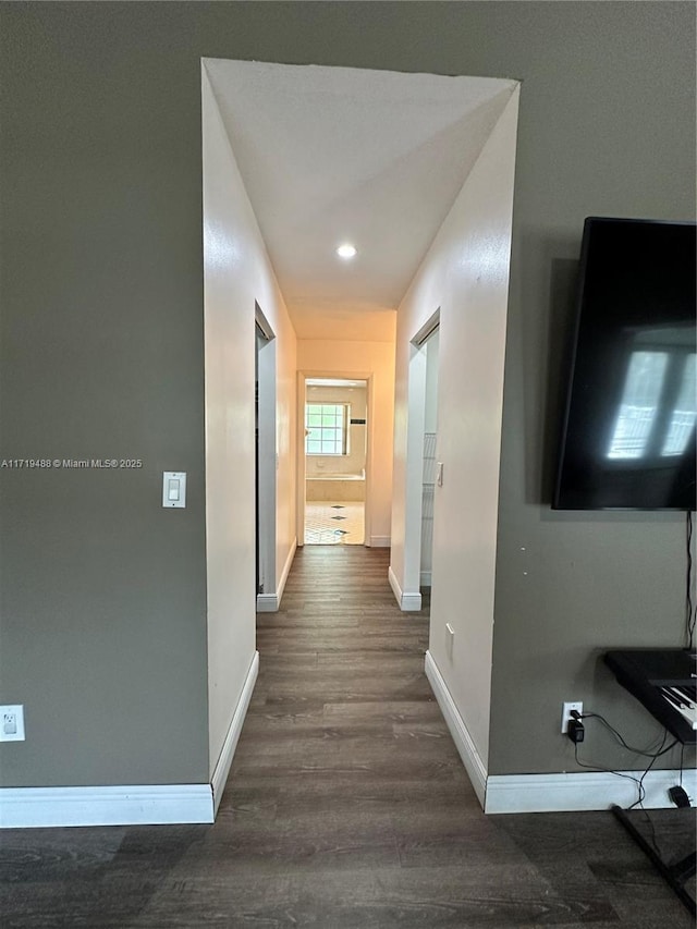 hall with dark hardwood / wood-style floors