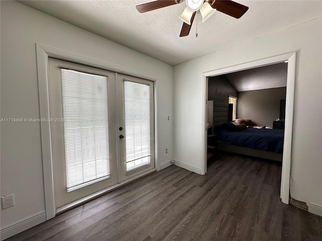 doorway featuring french doors, dark hardwood / wood-style flooring, a textured ceiling, and ceiling fan