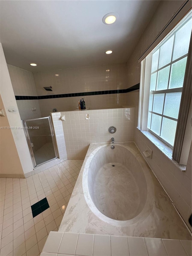 bathroom featuring tile patterned flooring and separate shower and tub