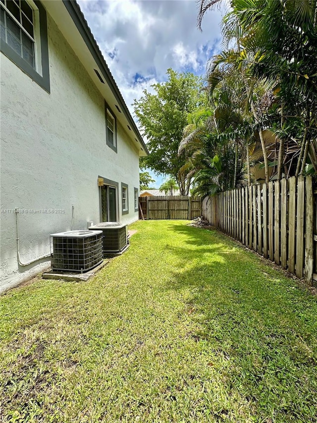 view of yard featuring central air condition unit