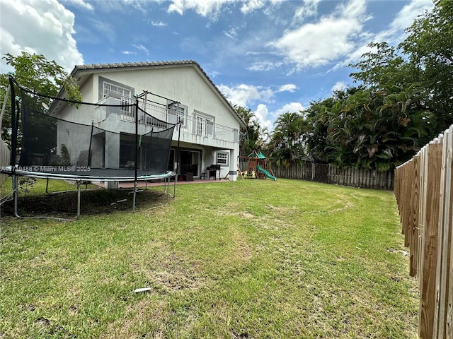 view of yard with a playground, a patio, and a trampoline