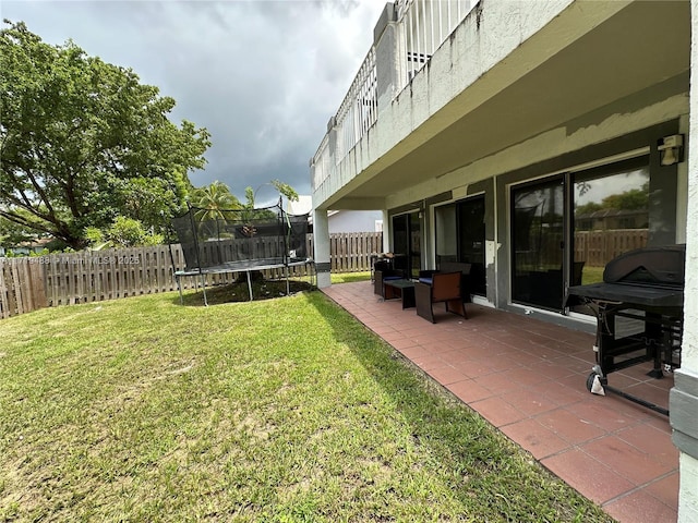 view of yard featuring a patio area and a trampoline