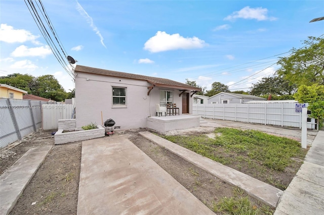 back of property featuring a patio