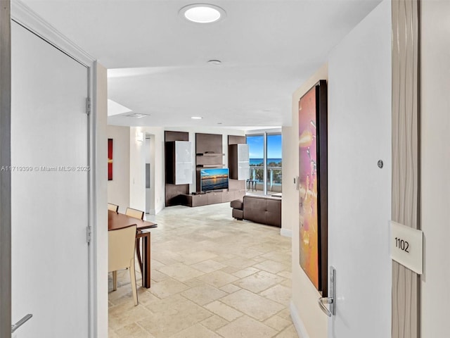 corridor featuring stone tile floors